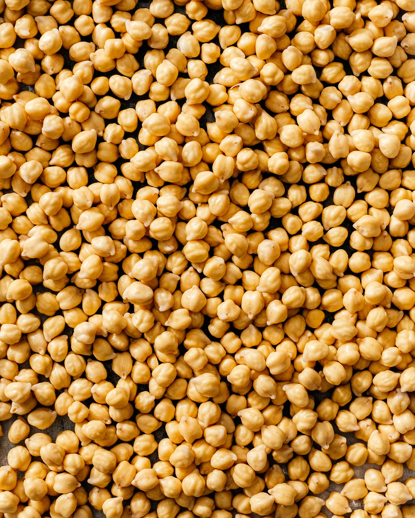 Place chickpeas and 1/2 teaspoon baking soda in a medium bowl and add cold water to cover by 2 inches. Cover and let sit, at room temperature overnight, until chickpeas have doubled in size. Drain and rinse.z